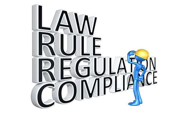 Blue person with yellow hard hat looking at the words law, rule, regulation, compliance.